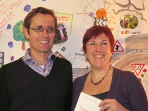 Nicki with Tom in front of the collage